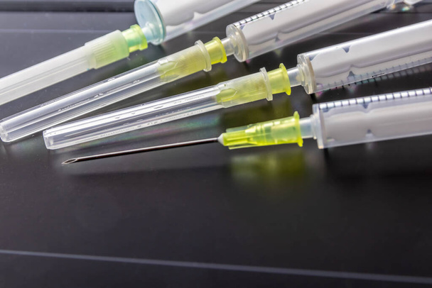 New medical vaccines ready for injection with syringe and vaccine to inject the cure for immunization into ill and weak patients to heal their suffers and illnesses supported corona health care system - Foto, Bild