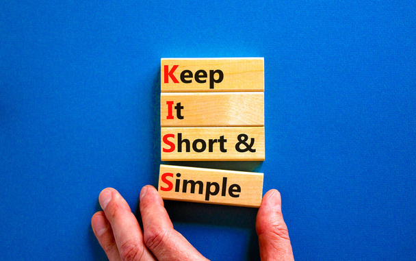 KISS keep it short and simple symbol. Concept words KISS keep it short and simple wooden blocks. Beautiful blue table, blue background. Business KISS keep it short and simple concept. Copy space. - Valokuva, kuva