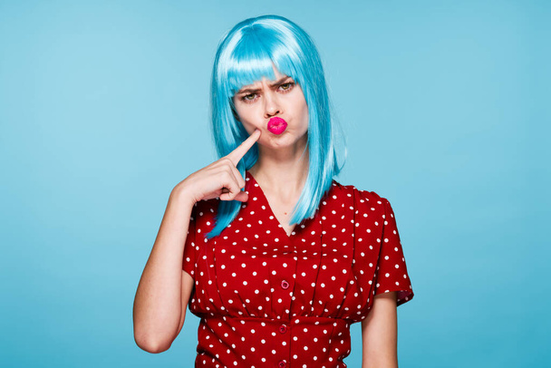 emotional woman in red dress blue wig red lips fashion - Foto, imagen