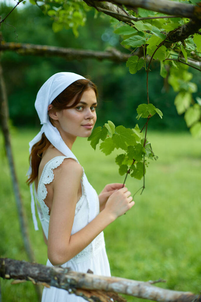 Woman in white dress in the village outdoors Green grass Farmer - Foto, imagen