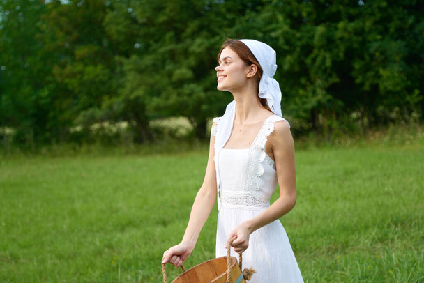 Woman in white dress in the village outdoors Green grass Farmer - Foto, afbeelding