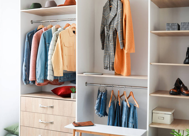 Wardrobe with stylish female clothes in walk-in closet - Photo, image