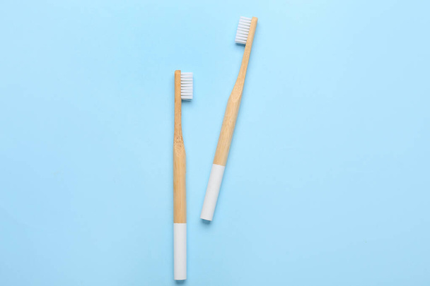 Wooden toothbrushes on blue background - Foto, Imagen