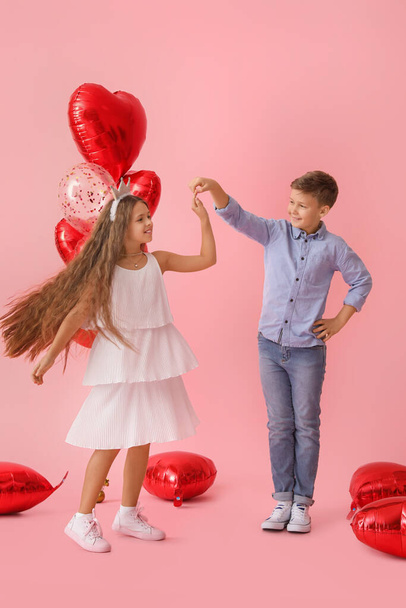 Dancing little children on color background. Valentine's Day celebration - Photo, Image