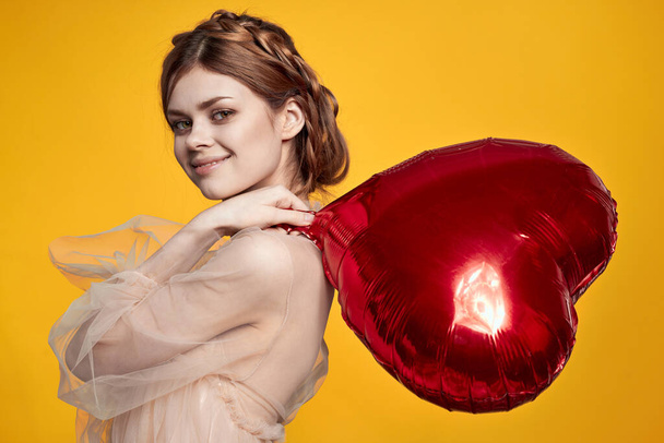 pretty woman red heart in the hands of the balloon isolated background - Foto, Imagen
