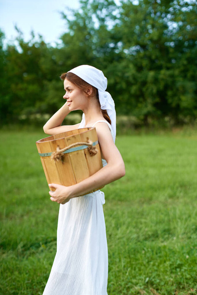 Woman in white dress in the village outdoors Green grass Farmer - 写真・画像