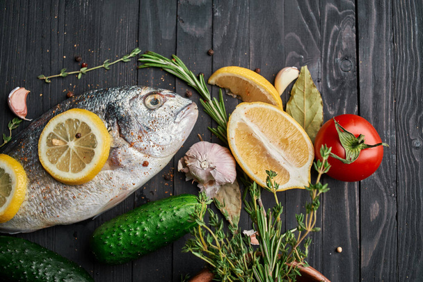 fish on wooden board ingredients lemon fresh food sea food - 写真・画像
