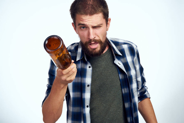 a man in a plaid shirt beer alcohol emotions fun light background - Fotografie, Obrázek