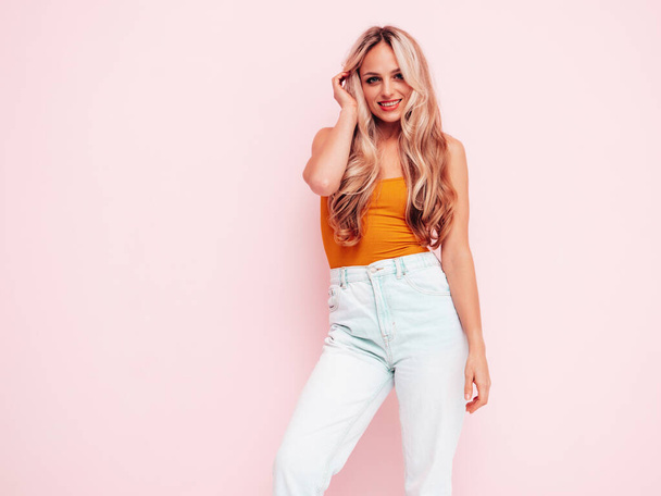 Portrait of young beautiful smiling female in trendy summer clothes. Sexy carefree blond woman posing near pink wall in studio. Positive model having fun indoors. Cheerful and happy - Φωτογραφία, εικόνα