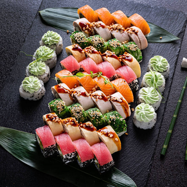 sushi on the black stone - Фото, изображение