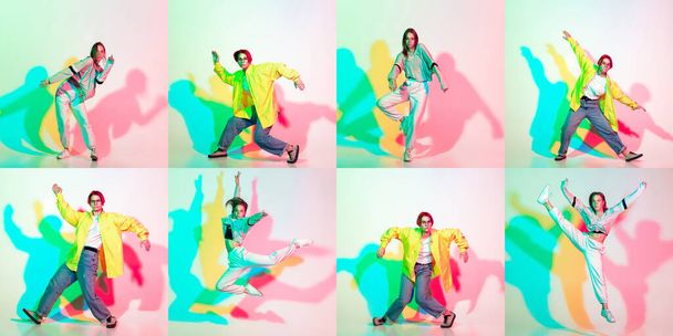Two stylish girls, teens dancing hip-hop in stylish clothes on colored studio background with glitch effect. - Foto, afbeelding