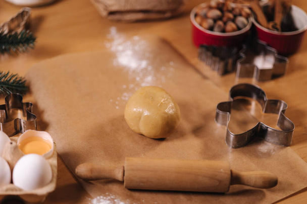 Home bakery, cooking traditional festive sweets. Preparing for making gingerbread dough on wooden table. New Year celebration traditions. Christmas mood - Fotografie, Obrázek