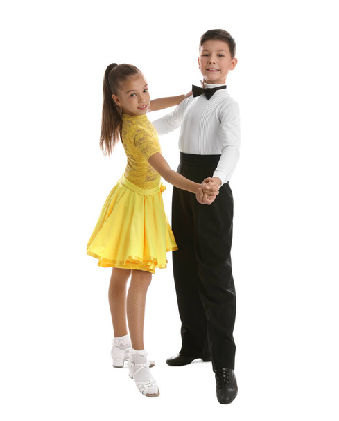 Beautifully dressed couple of kids dancing on white background - Foto, imagen