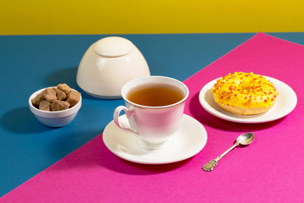 Tea with dessert on a bright colored background - Photo, Image