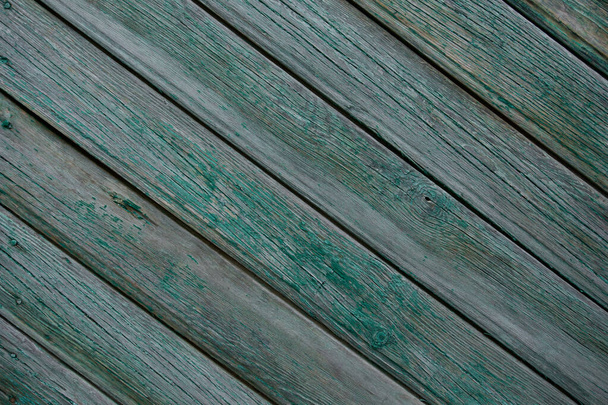 texture of a wooden fence.  fence painted green.  peeling paint on an old fence.  old wood texture.  photo can be used as a photophone, as a texture - Zdjęcie, obraz