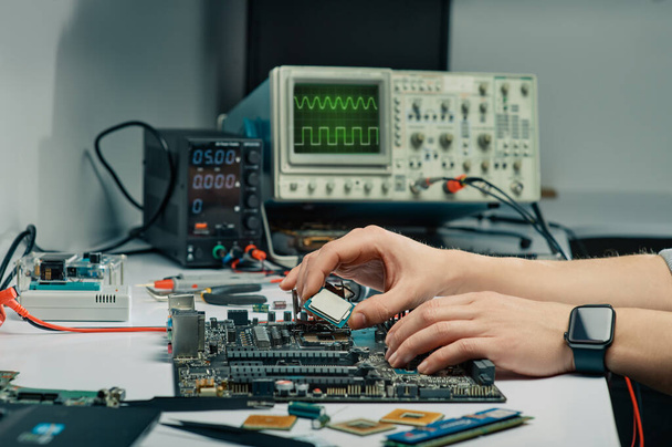 Technician plug in CPU microprocessor to motherboard socket. - Фото, зображення