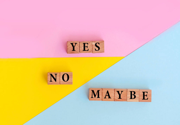 Yes, No and Maybe Words with Wooden Cubes on Colorful Background - Foto, afbeelding