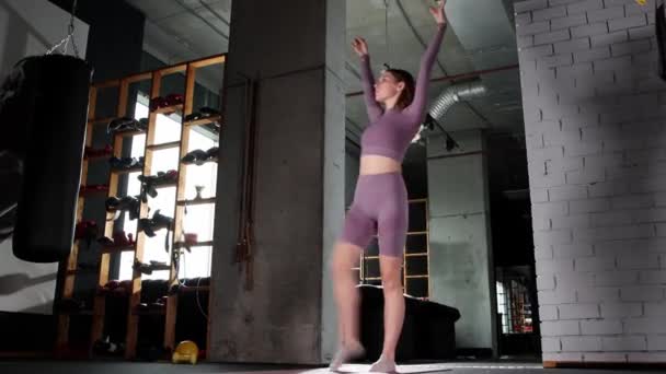 Mujer joven jugando con una cuerda de salto en el gimnasio - Metraje, vídeo