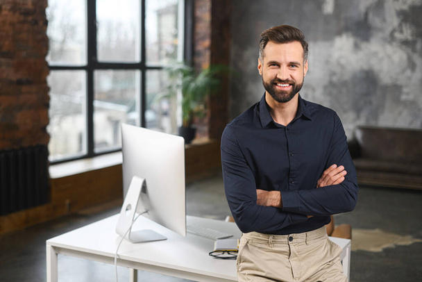 Proud and successful young businessman in smart casual wear with arms crossed - Фото, зображення