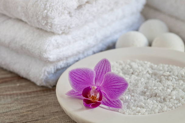zen style still life with towels and orchid, perfect for spa theme layouts, wellness blog or home decor and wall art - Photo, Image