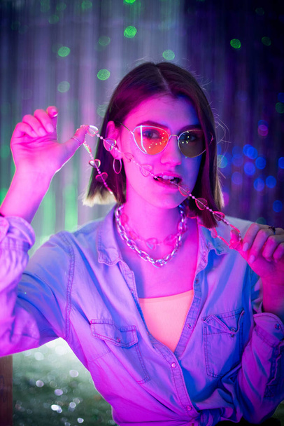 Cinematic night portrait of girl and neon lights. Fashion. Woman in Colorful neon light. girl in disco, makeup dance. Party disco neon nightclub vibes. creative art neon pink blue light. - Photo, Image