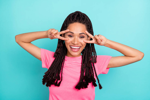 Photo of cool brunette hairdo millennial lady show v-sign wear pink t-shirt isolated on teal color background - Zdjęcie, obraz