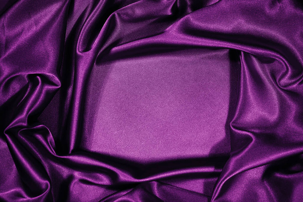 Purple magenta silk satin velvet. Beautiful soft wavy folds. Table top view. Flat lay. Shiny fabric backdrop with copy space for design, montage. Christmas, Valentine. - Foto, afbeelding