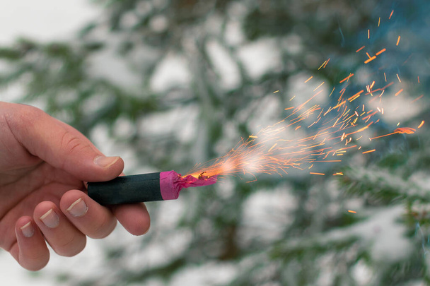 Burning Firecracker in a Hand. Sparks and Smoke of Petard - Valokuva, kuva