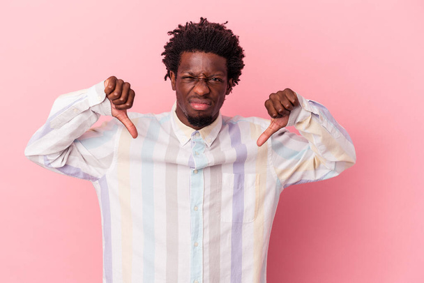 Young african american man isolated on pink background showing thumb down, disappointment concept. - Photo, Image