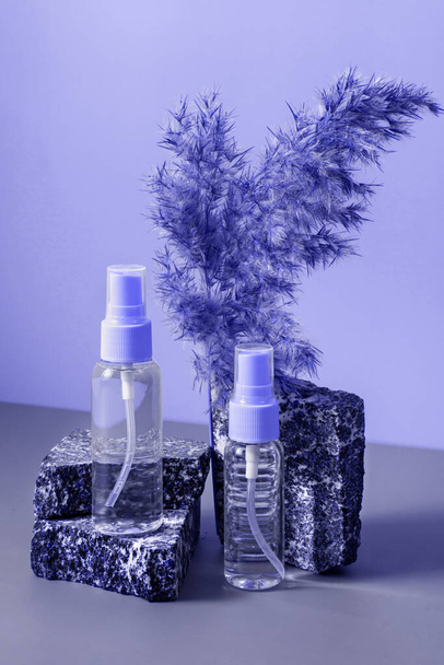 A set of cosmetics on a fashionable very peri color background on a stone podium. Healthy cosmetology, the concept of spa treatment. - Foto, Imagem