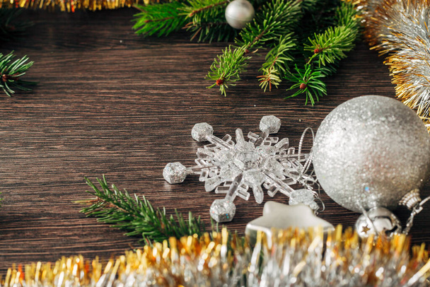 Christmas Tree Branches and Snowflakes on a Brown Background with Copy Space - Фото, изображение
