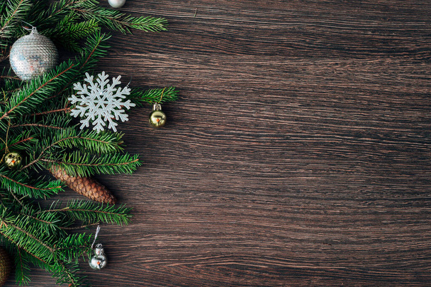 Christmas Tree Branches and Snowflakes on a Brown Background with CopySpace - Photo, Image