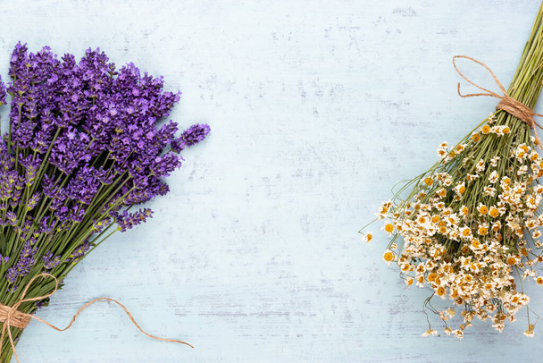 Essential oil and lavender, chamomile salt with flowers top view. - Фото, изображение