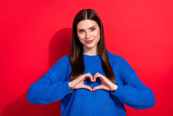 Photo portrait brunette in casual pullover showing heart sign isolated vibrant red color background - Fotó, kép