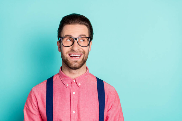 Photo of young man happy positive smile dream think guess wonder look empty space isolated over teal color background - Φωτογραφία, εικόνα