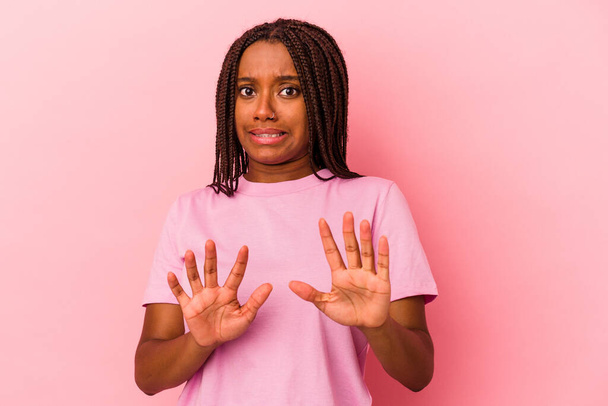 Young african american woman isolated on pink background  rejecting someone showing a gesture of disgust. - Photo, Image