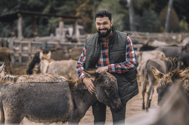 A farmer with his animals at the fram - 写真・画像