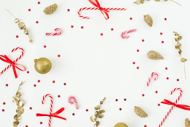Christmas frame with decoration, confetti and candy canes. Flat lay, top view. New Year celebration - Φωτογραφία, εικόνα