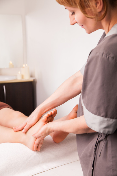 Foot massage for a woman in luxury spa - Photo, Image