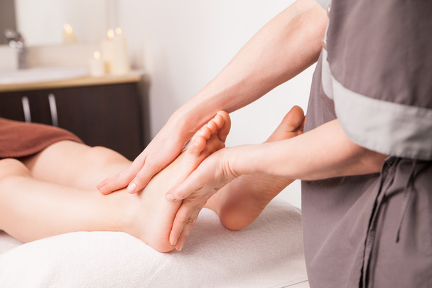 Foot massage for a woman in luxury spa - Φωτογραφία, εικόνα