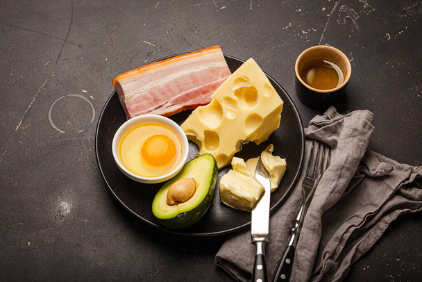 Foods for keto diet on black plate on dark background copy space - Photo, Image