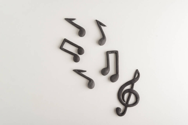 Хаотично устроенный тройной ключ и ноты на белом фоне. Музыкальный символ. Тематическая музыка - Фото, изображение