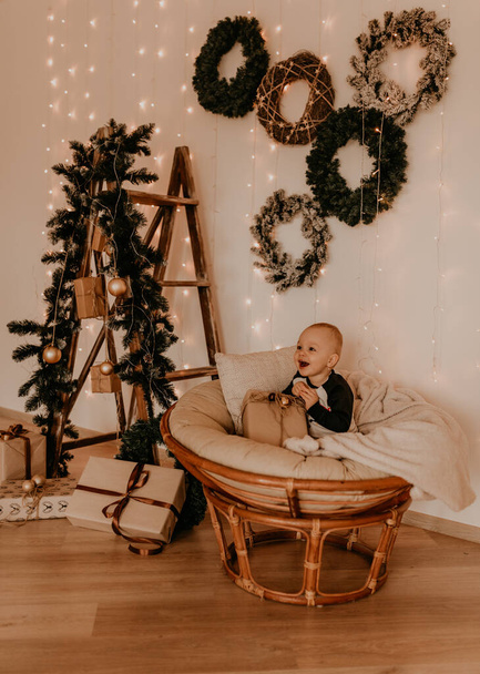 little baby girl sitting in chair and playing. Christmas morning. New Year's interior. Valentine's Day celebration - Foto, Imagen