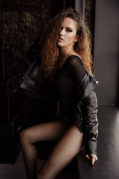 Portrait of a amazing red haired curly girl in a black leather jacket - Zdjęcie, obraz
