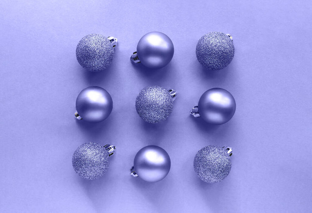 Purple Christmas balls in a square on a light purple background - Фото, изображение