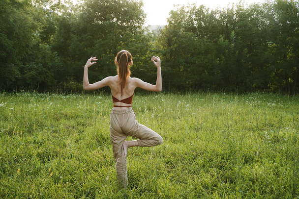 woman in a field outdoors summer meditation fresh air - Фото, зображення