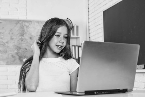 cheerful child work on laptop in school classroom during online modern education, home schooling - Fotografie, Obrázek