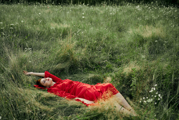 woman in a black dress lies in a field nature fashion summer - 写真・画像