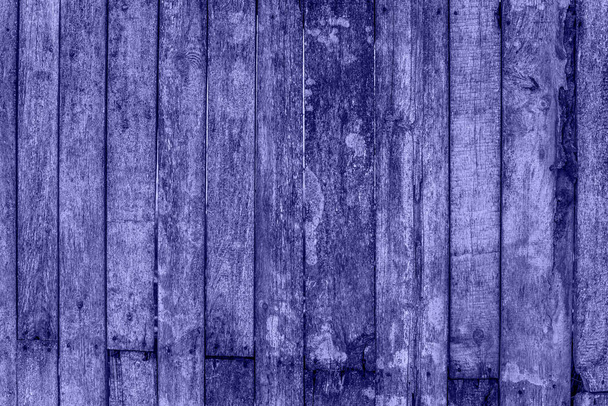 Trendy Color of Year. Very peri. 2022. fence made of wood. Wooden background with weathered wood - Φωτογραφία, εικόνα