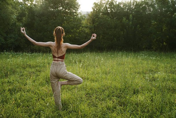 woman in a field outdoors summer meditation fresh air - Φωτογραφία, εικόνα
